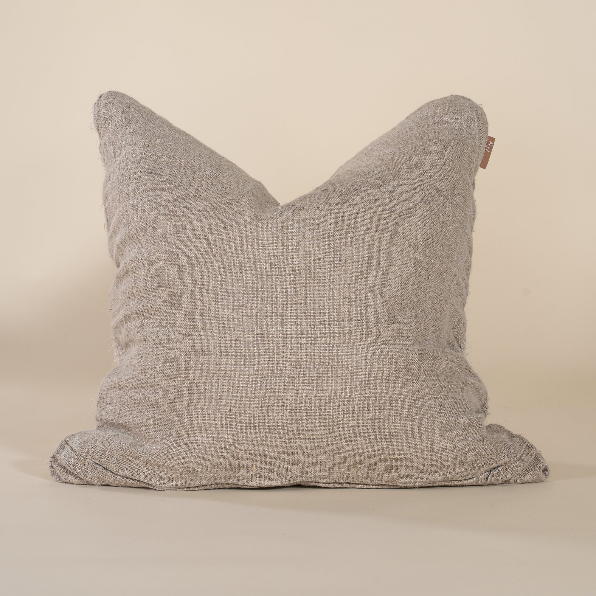 A natural woven cushion with a rich, textured finish, perfect for adding warmth and organic elegance to any sofa or bed. Handcrafted for a timeless aesthetic