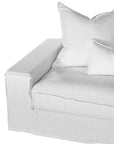 White linen slipcover sectional sofa with plush cushions. A timeless, versatile design offering relaxed elegance and everyday comfort