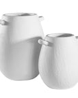 A set of two sculptural white ceramic vases with a textured finish and organic curved handles, perfect for modern and minimalist styling