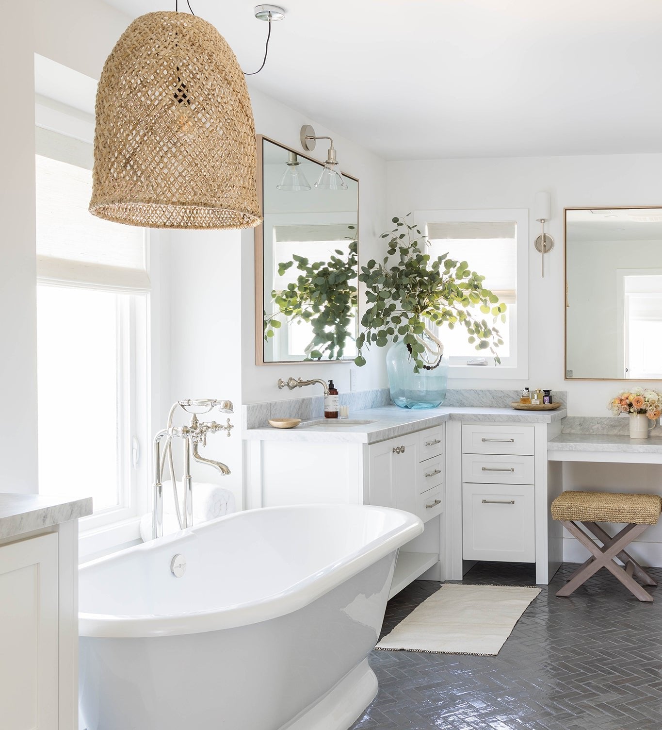 Luxury bathroom with a woven pendant light, freestanding bathtub, and elegant neutral decor creating a serene, spa-like retreat