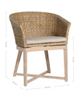 KULALA Living handwoven rattan dining chair with a curved backrest, natural wood legs, and a neutral seat cushion, blending coastal and contemporary design