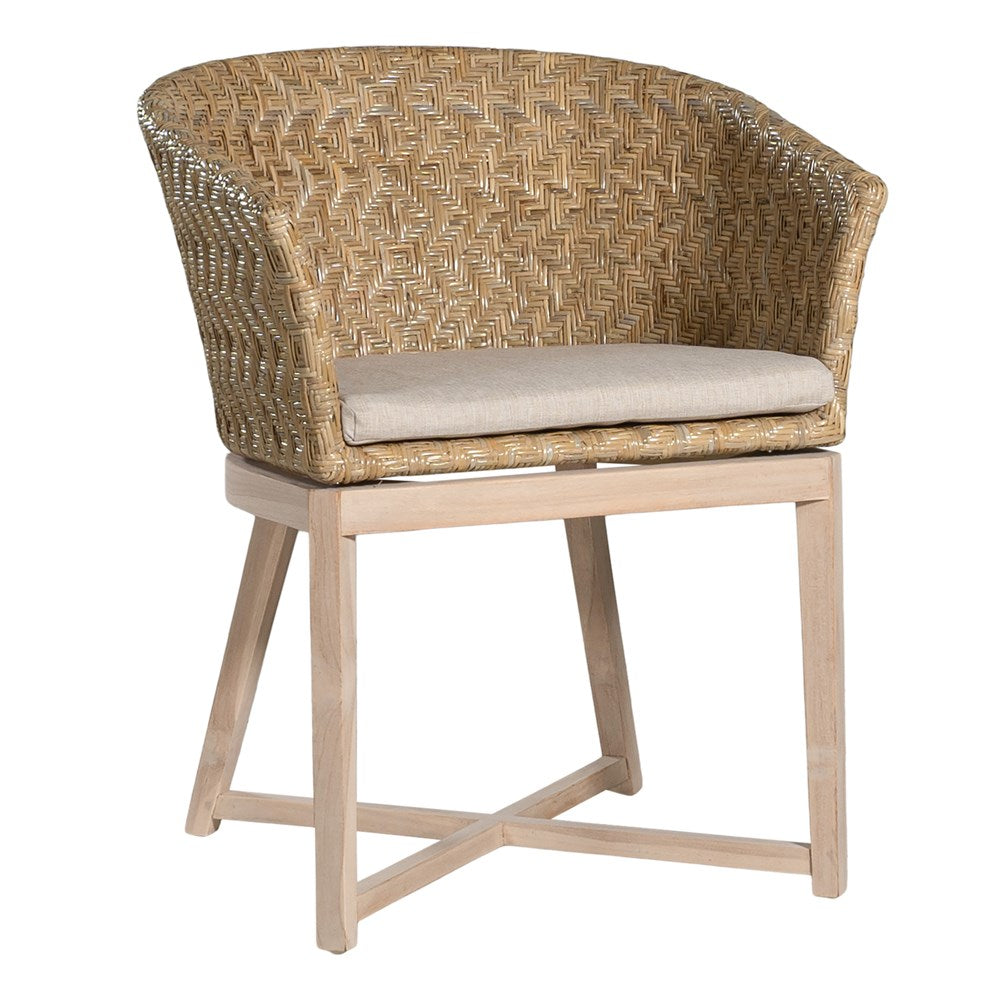 KULALA Living handwoven rattan dining chair with a curved backrest, natural wood legs, and a neutral seat cushion, blending coastal and contemporary design